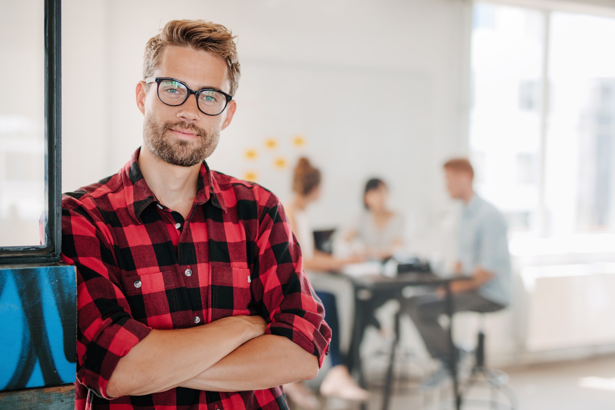 Portrait of positive businessman in office